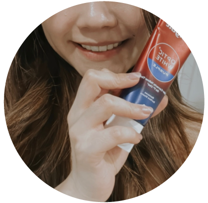 woman with Colgate Optic White Purple Toothpaste woman with Colgate Optic White Purple Toothpaste