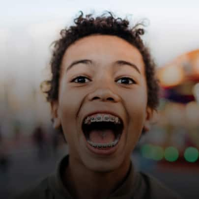 A kid with a bright smile with braces | Sparking optimism in everyone, every day