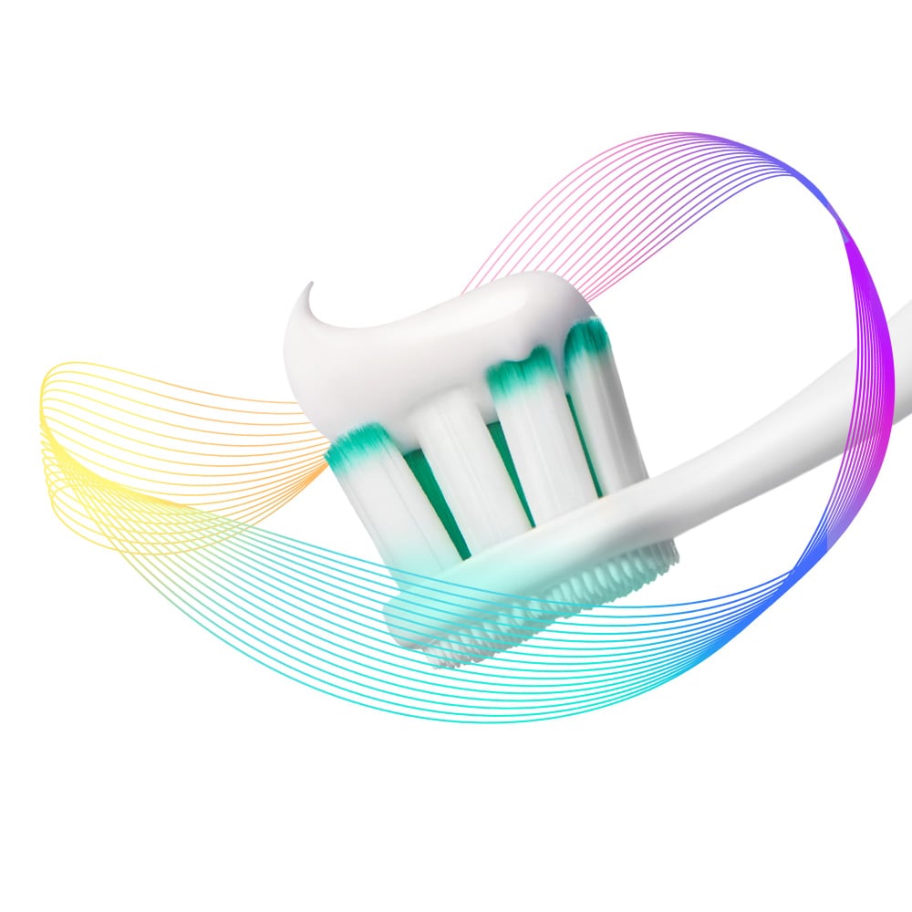 The Colgate Total toothbrush head with paste on it, surrounded by multi-coloured prevention rays