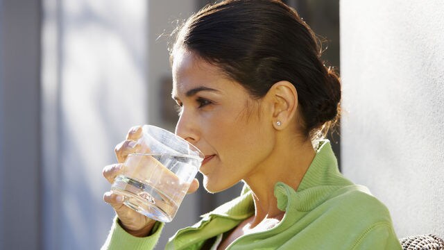 woman drinking a glass of water