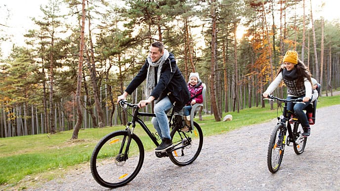 a family smiling riding bikes