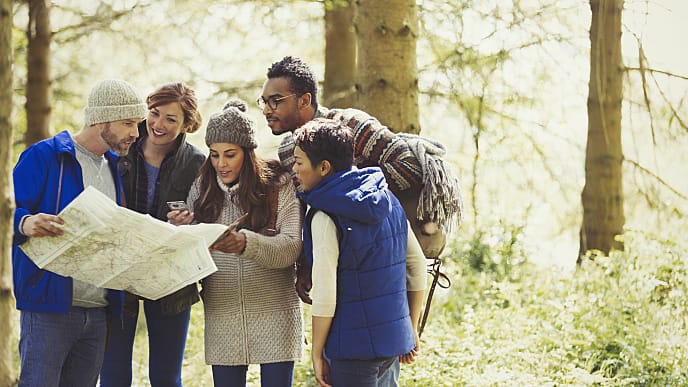 Friends Looking at a Map on a Hike