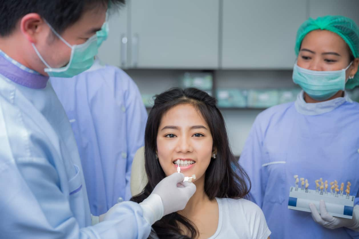 woman having an oral cancer screening with her dr.