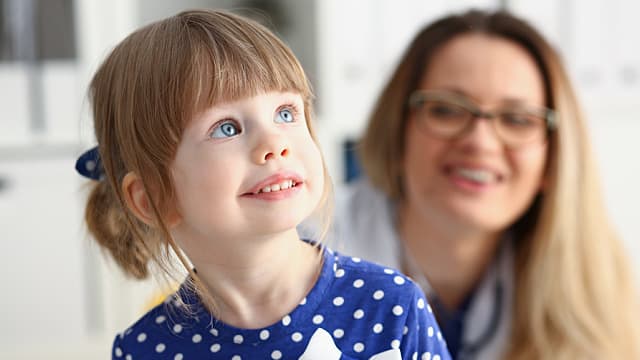 A Child Smiles in a Dentist's Office Awaiting a Routine Oral Exam