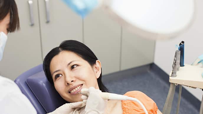 woman receiving novocaine from her dentist