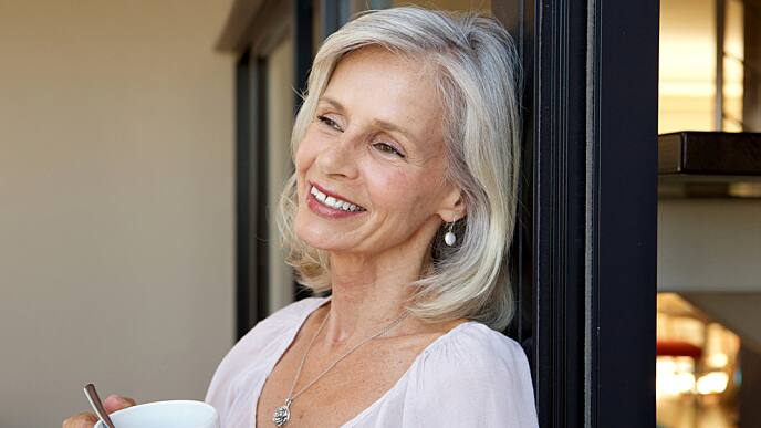 older woman smiling and drinking coffee older woman smiling and drinking coffee