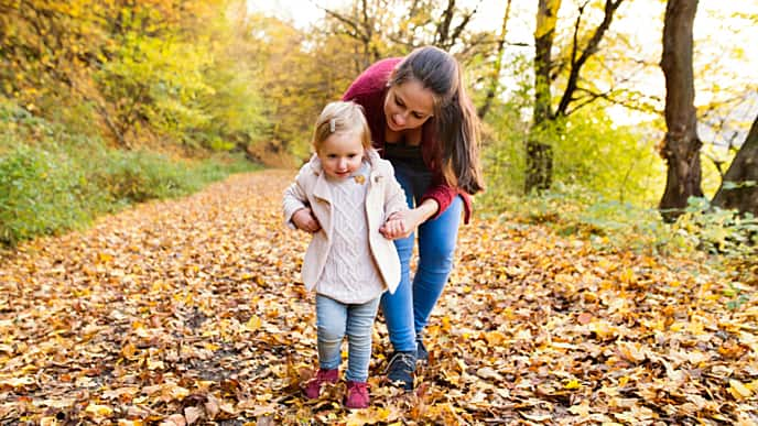 Mother teaching her daughter how to walk