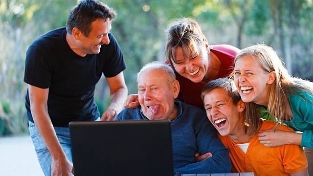 Funny grandpa making funny faces and families are laughing together