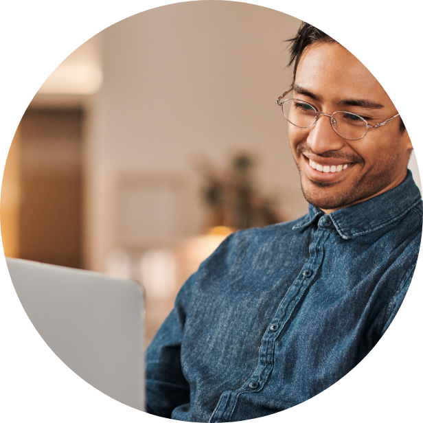 Smiling Man Looking at Computer Screen