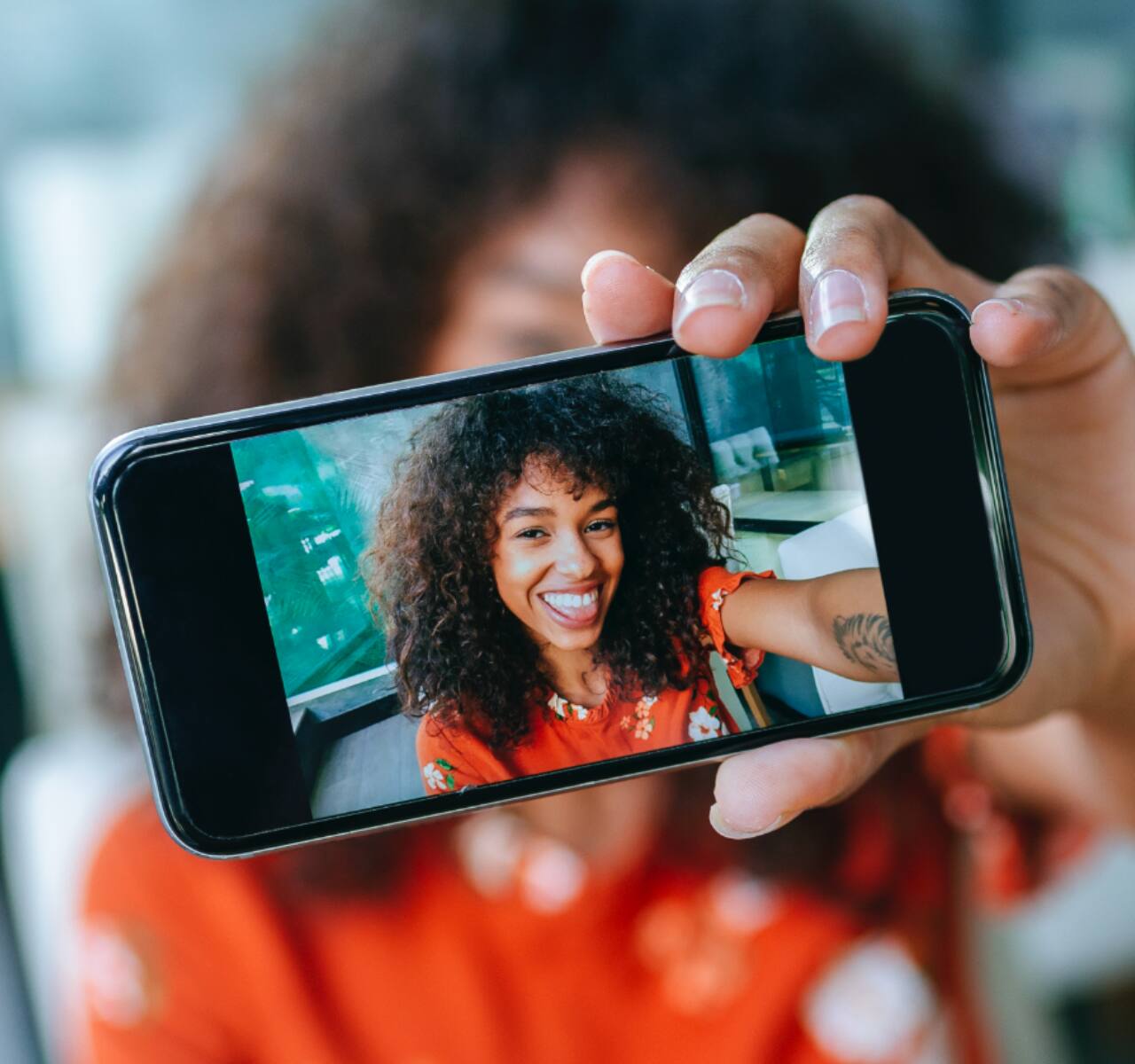 woman taking a selfie and showing her white teeth