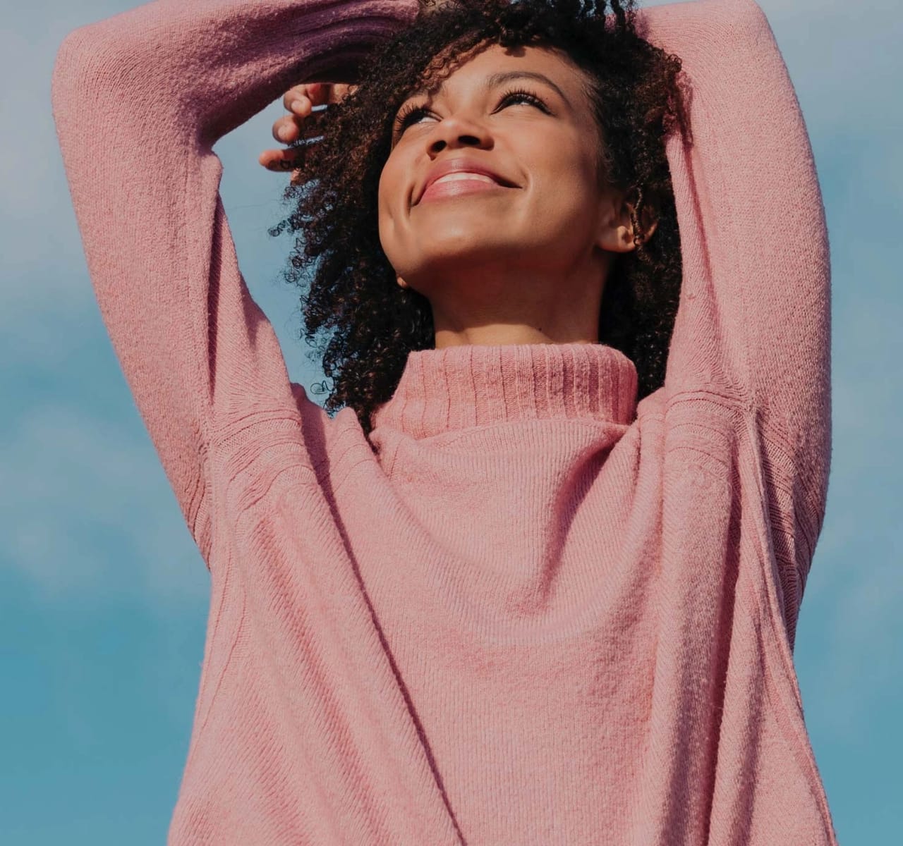 Woman looking to the sky and smiling