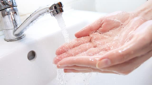 Close up of the woman's hands over the sink