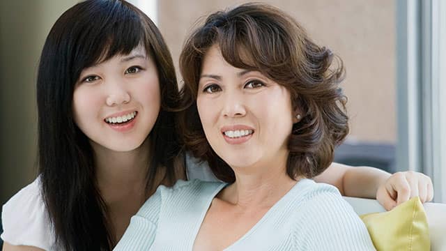 Asian mom and daughter smiling