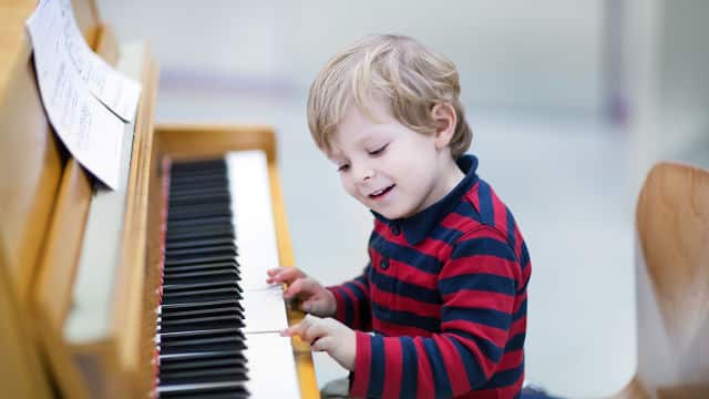 young boy playing the piano