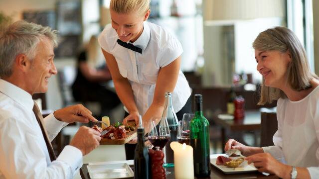 Senior couple enjoying food and wine in a restaurant