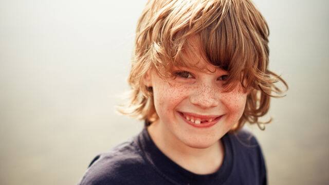 Young boy smiling at the camera