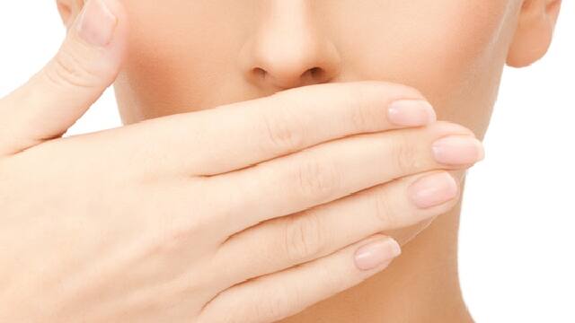 a young women is tesing if she has bad breath on her own