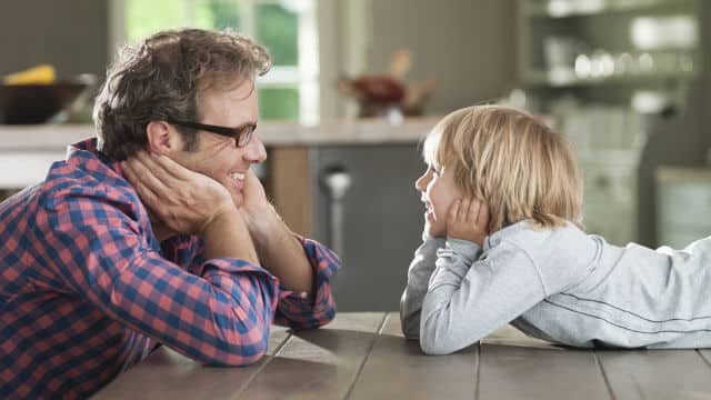 Father and son looking at each other and smiling