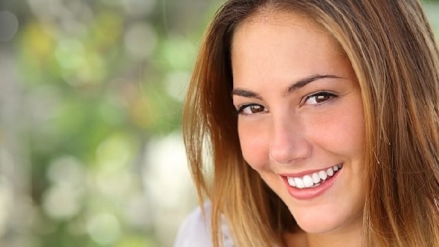 a woman smiling brightly