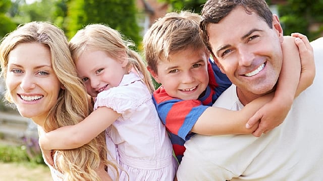 parents and children are happy together with healthy gums