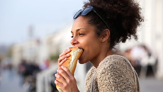 woman eating a sandwich outdoor