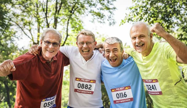 Group of cheerful senior runners at the park