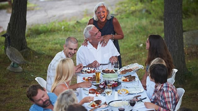 A family is eating together happily after gingival hyperplasia treatment