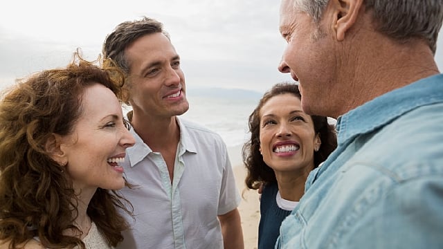 a group of friends are talking happily after white gums treatment