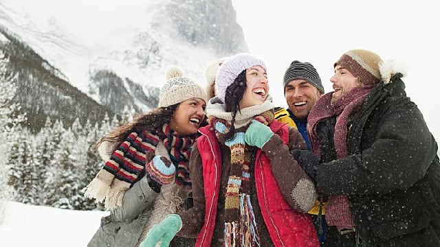 Group of friends laughing and enjoying outdoors in winter