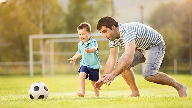 father playing with child after dental procedure with laughing gas