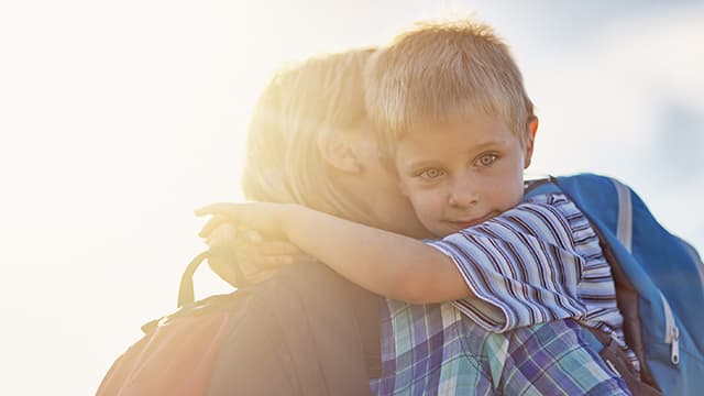 boy hugging his mother