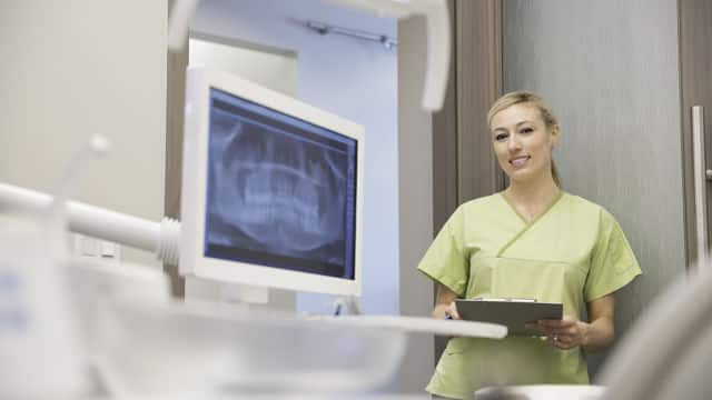 a dental nurse holding a chart