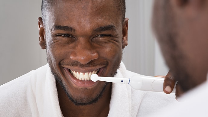Man brushing gums no longer bleeding