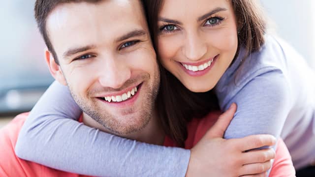 Happy loving couple with a healthy white smile