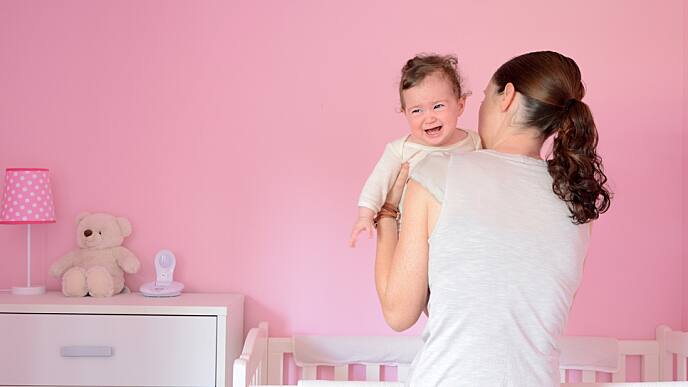 mother putting her baby to sleep