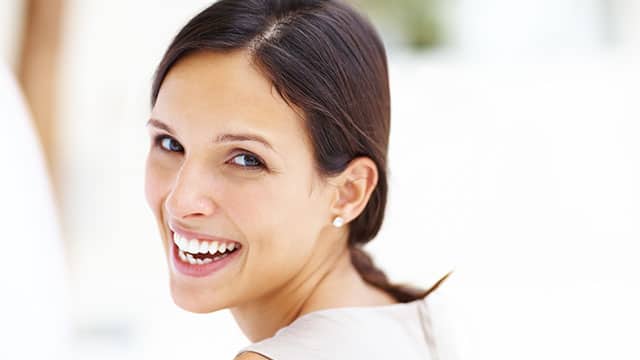 a lady smiling with bright white teeth