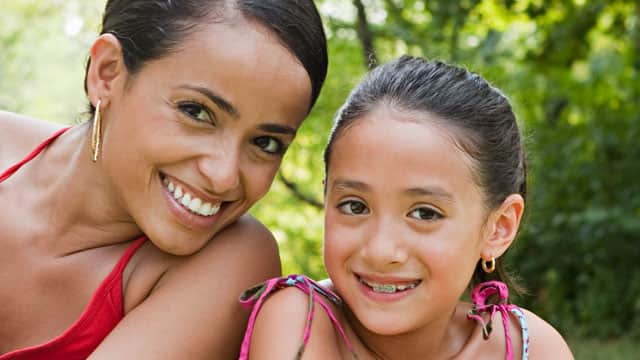 Mother and daughter wearing braces outside