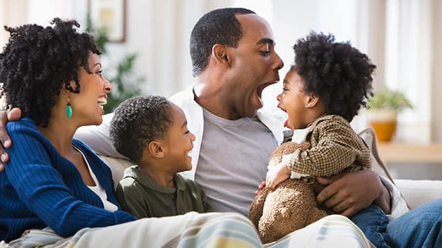 Parents with two children on a couch