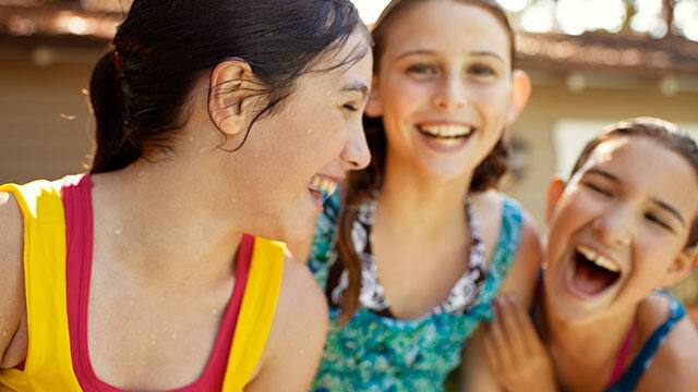 Three girls are playing outdoors Three girls are playing outdoors