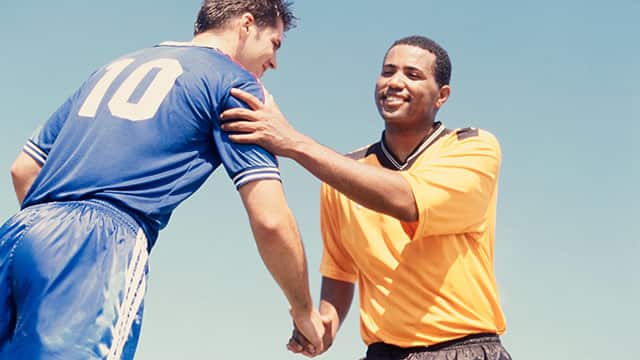Two soccer players having a handshake Two soccer players having a handshake