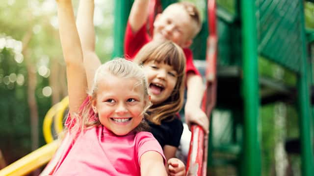 Children on slide outdoors