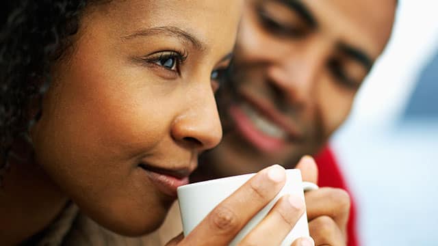 A woman is drinking from the cup