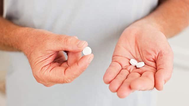 A close up of the man holding pills A close up of the man holding pills
