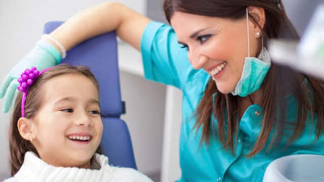 A girl and a dentist in the dentist's office