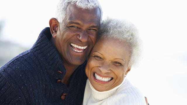 Middle age couple smiling outside