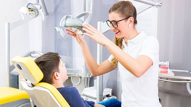 A kid and a dentist in the office A kid and a dentist in the office