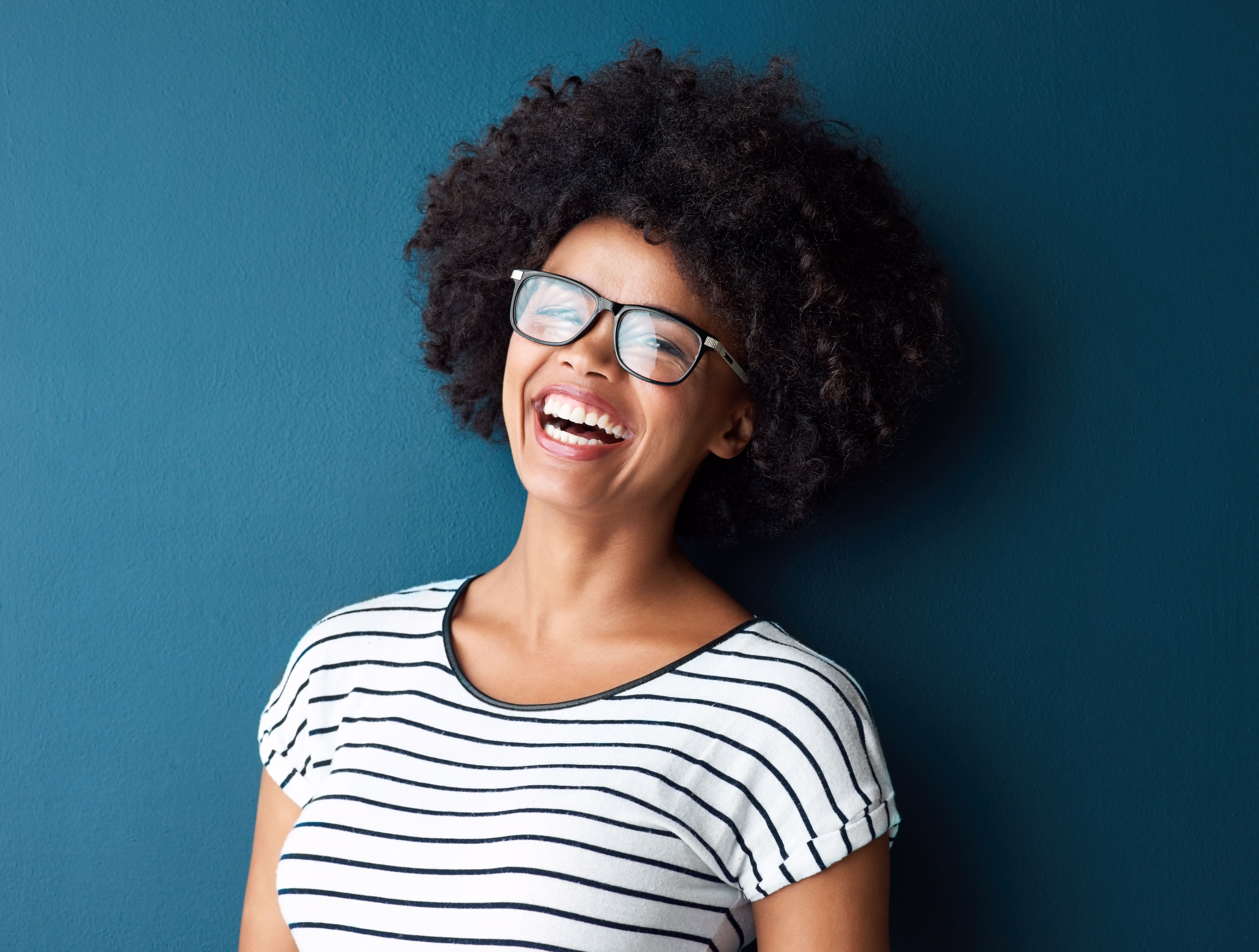 A young woman smiling indoors