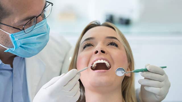 Dentist checking a patient Dentist checking a patient