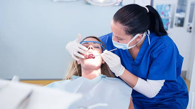 A dentist at work with the patient