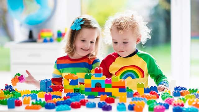 Kids playing with colorful plastic blocks